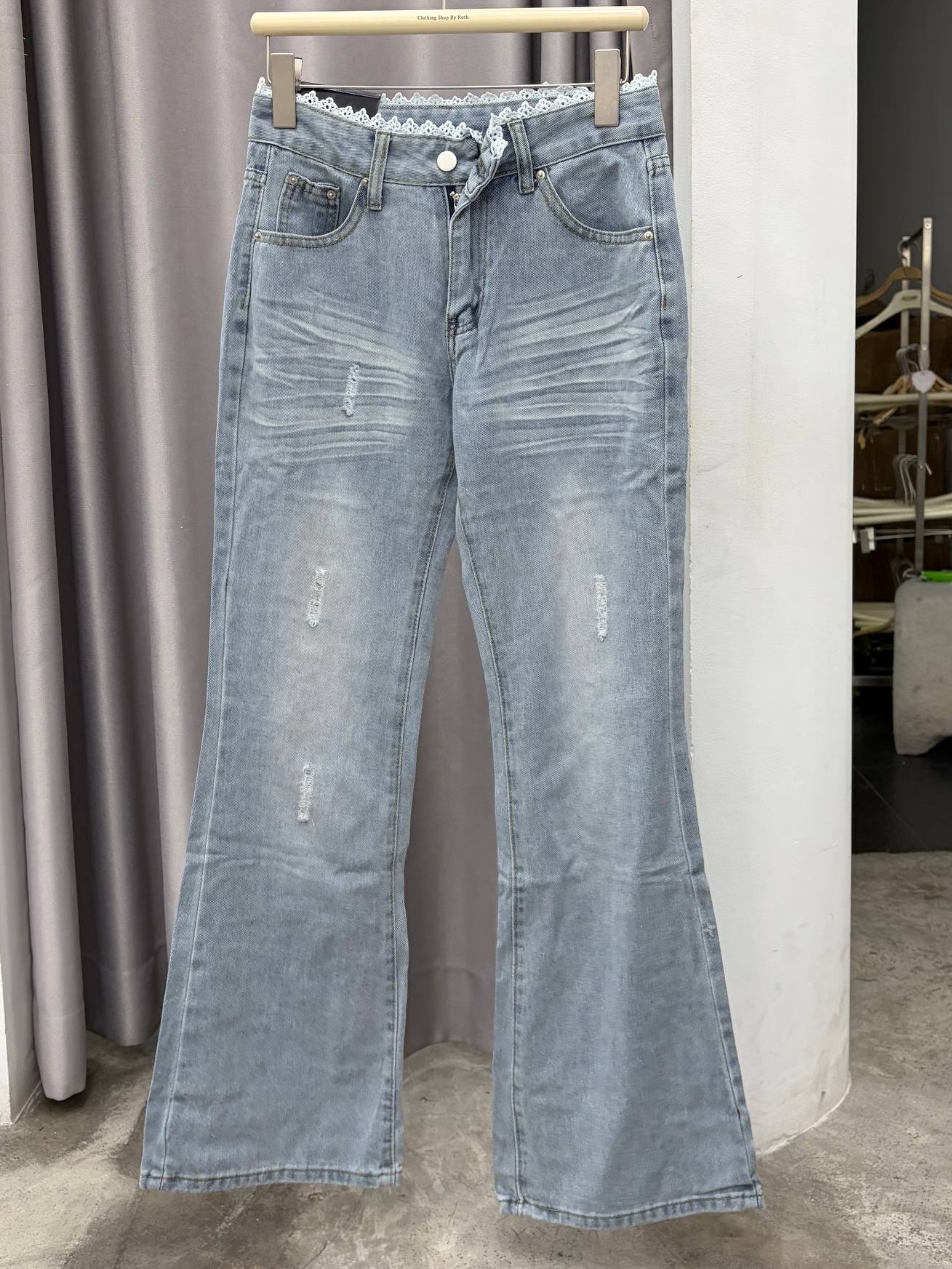 lace-trimmed distressed flare jeans